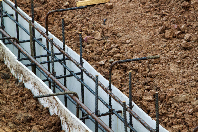 close up view of reinforcement of concrete with metal rods connected by wire. Preparation for pouring the Foundation